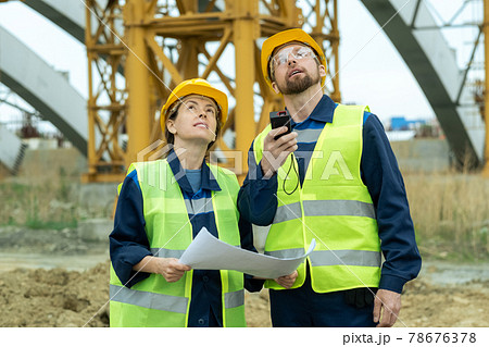 Two young builders looking upwards 78676378