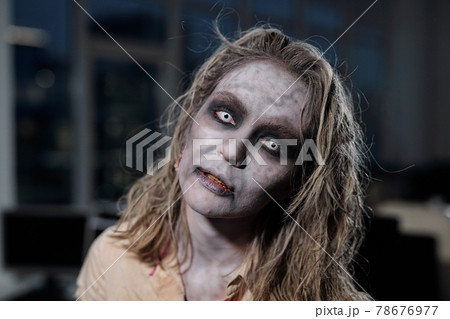 Zombie female standing in dark room or office 78676977
