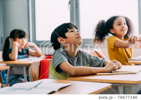 Kids listening and focusing on class in school Kids listening and focusing on class in school 78677386