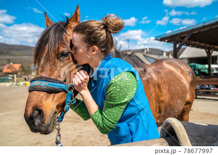 portrait of a horse with a young woman 78677997