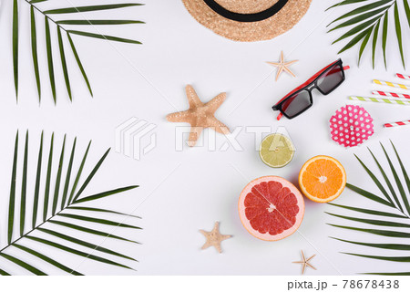 Beach accessories: glasses and hat with shells and sea stars on a white background Beach accessories: glasses and hat with shells and sea stars on a white background 78678438