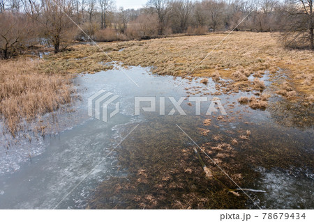 Frozen floodplain from drone perspective in winter. 78679434