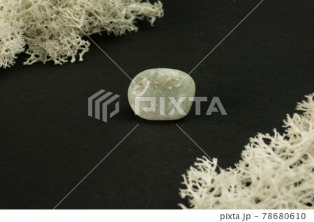 Jadeite from India. Natural mineral stone on black background. Mineralogy, geology, magic of stones, semi-precious stones and samples of minerals. Close-up macro photo. 78680610