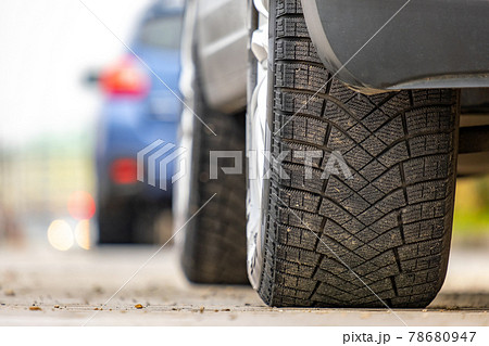 Closeup of parked car on a city street side with new winter rubber tires. 78680947