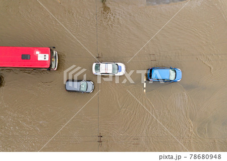Aerial view of traffic cars driving on flooded road with rain water. 78680948
