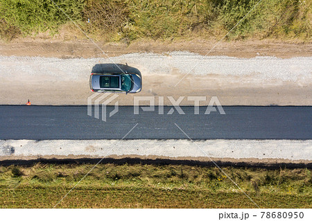Aerial view of new road construction with newly layed black asphalt lane. 78680950