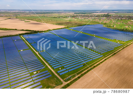 Aerial view of big sustainable electric power plant with many rows of solar photovoltaic panels for producing clean ecological electrical energy. Renewable electricity with zero emission concept. Aerial view of big sustainable electric power plant with many rows of solar photovoltaic panels for producing clean ecological electrical energy. Renewable electricity with zero emission concept. 78680987