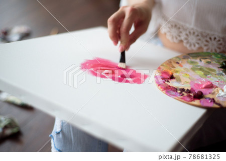 Woman artist drawing her picture on canvas with oil colors at home Woman artist drawing her picture on canvas with oil colors at home 78681325