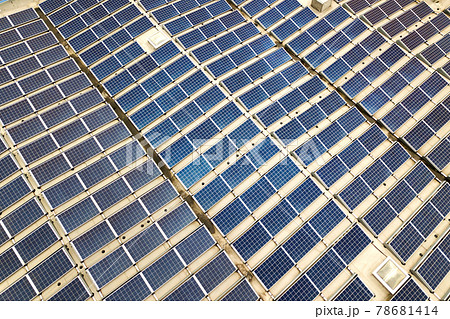Aerial view of solar power plant with blue photovoltaic panels mounted of industrial building roof. 78681414