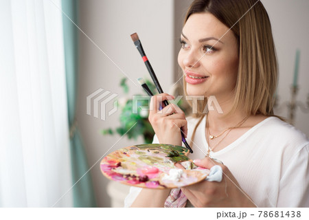 Art, creativity, job and creative occupation concept. Female artist posing in front of window and Art, creativity, job and creative occupation concept. Female artist posing in front of window and 78681438