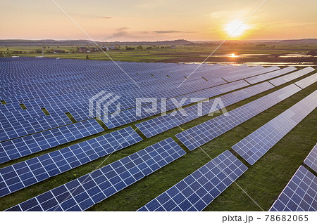 Blue solar photo voltaic panels system producing renewable clean energy on rural landscape and setting sun background. Blue solar photo voltaic panels system producing renewable clean energy on rural landscape and setting sun background. 78682065