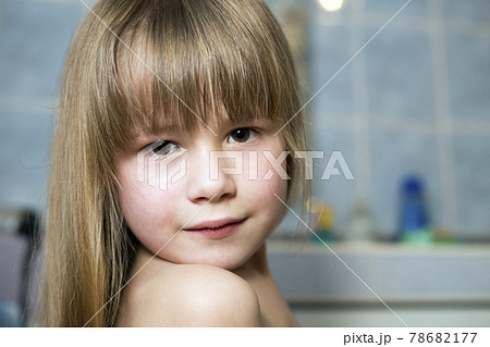 Pretty girl face portrait, smiling child with beautiful eyes and long wet fair hair on blurred background of bathroom. Pretty girl face portrait, smiling child with beautiful eyes and long wet fair hair on blurred background of bathroom. 78682177