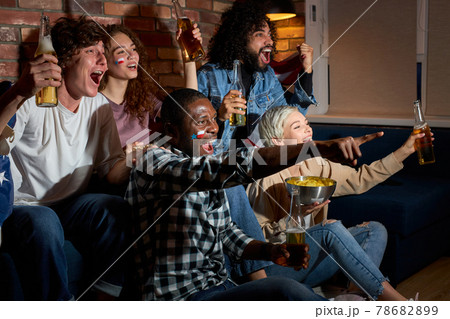 Yeah. Group of friends watching sport competition on TV together 78682899