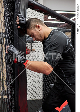 Side view on fitness sporty tired man spend time in gym practicing boxing, have rest Side view on fitness sporty tired man spend time in gym practicing boxing, have rest 78683002