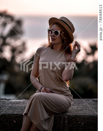Gorgeous wealthy redhead woman at summer sunset Gorgeous wealthy redhead woman at summer sunset 78688613