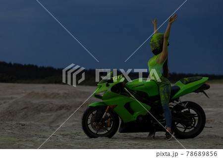 Cool woman in helmet on motorbike on beach 78689856