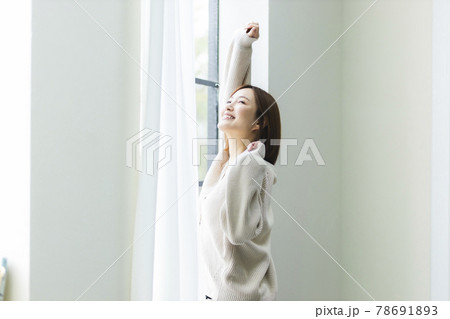 朝日を浴びて伸びをする女性 朝日を浴びて伸びをする女性 78691893