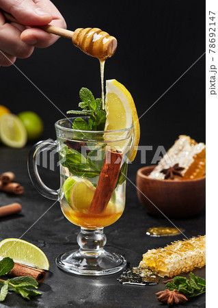Oriental style tea with lime, cinnamon, anise, honey, mint 78692147