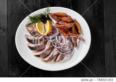 Salted herring with fried potato wedges, onion, lemon 78692193