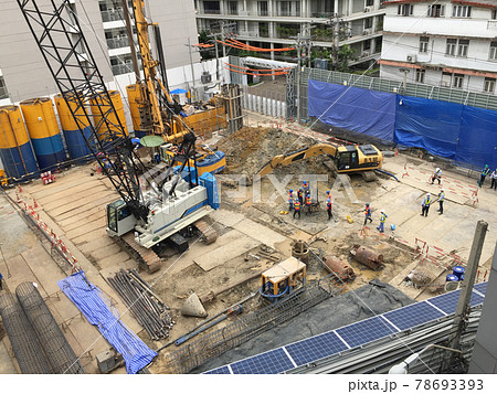 Workers in the construction area with a crane truck and holding machine Workers in the construction area with a crane truck and holding machine 78693393