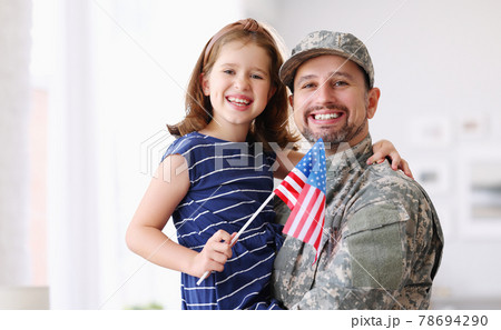 Happy young father in military uniform reunited with cute little daughter at home Happy young father in military uniform reunited with cute little daughter at home 78694290