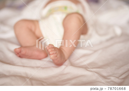 Baby legs on white sheet, newborn baby 1 month, care and love Baby legs on white sheet, newborn baby 1 month, care and love 78701668