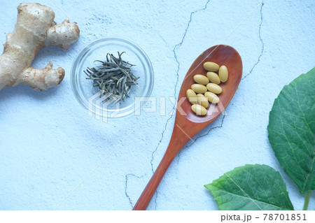 herbal medicine on spoon and herbs on table , herbal medicine on spoon and herbs on table , 78701851