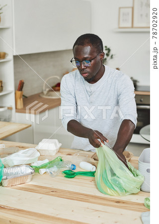 Man sorting the rubbish at home Man sorting the rubbish at home 78702920