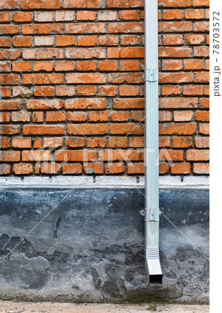 old red brown brick wall and drain pipe for background or texture 78703572