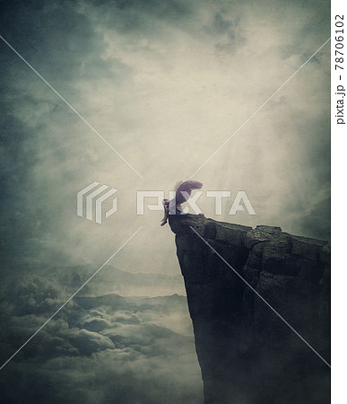 Surreal scene with an angel fallen in limbo, sitting alone on the edge of a cliff between the skies. Magical winged creature expelled from paradise. Metaphorical and conceptual imaginary world view Surreal scene with an angel fallen in limbo, sitting alone on the edge of a cliff between the skies. Magical winged creature expelled from paradise. Metaphorical and conceptual imaginary world view 78706102