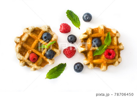 Traditional belgian waffles with blueberries and raspberries Traditional belgian waffles with blueberries and raspberries 78706450
