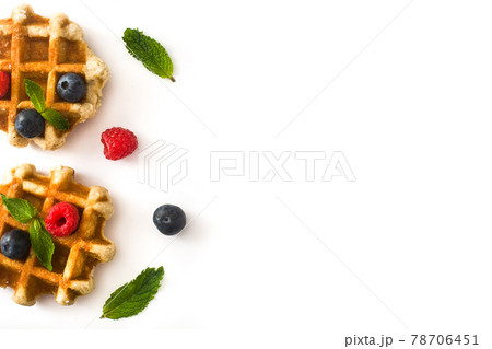Traditional belgian waffles with blueberries and raspberries Traditional belgian waffles with blueberries and raspberries 78706451
