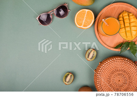 Summer composition. Sunglasses mango, orange, kiwi on green background. Flat lay Summer composition. Sunglasses mango, orange, kiwi on green background. Flat lay 78706556