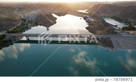 Sunset with a view of the dam and bridge. 78706971