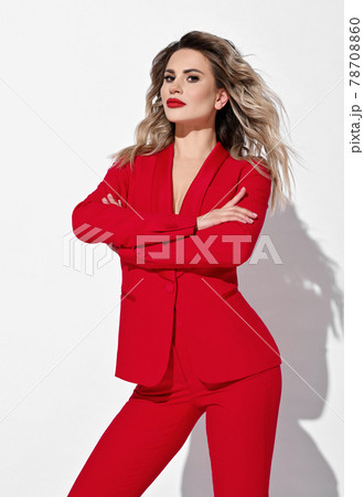 Sexy blonde curly businesswoman in red pantsuit Sexy blonde curly businesswoman in red pantsuit 78708860