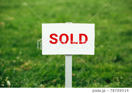land sold plate sign, green grass background land sold plate sign, green grass background 78709514
