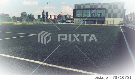 football field with markings. Football stadium. Sports background. Sports center in the city. Vintage or retro style. White vignetting around the edges football field with markings. Football stadium. Sports background. Sports center in the city. Vintage or retro style. White vignetting around the edges 78710751