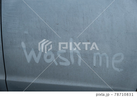 Finger lettering wash me in a dirty blue car. 78710831