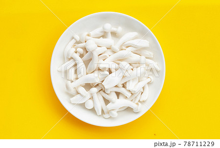 White beech mushrooms, Shimeji mushroom, Edible mushroom on yellow background. 78711229