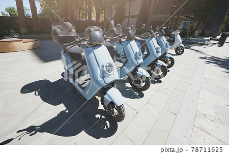 Row of moto scooters parked for rent 78711625