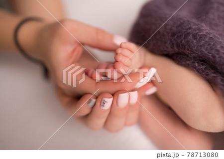 Children's feet in hold hands of mother and father. Mother, father and Child. Happy Family people concept. 78713080
