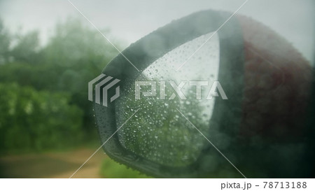 Wet rearview mirror of a car on a rainy day 78713188