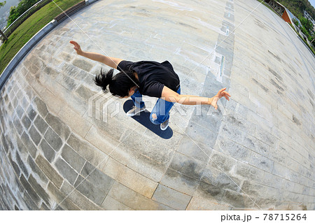 Skateboarder skateboarding outdoors in the morning 78715264
