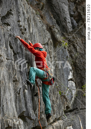 Woman rock climber climbing on the cliff Woman rock climber climbing on the cliff 78715610