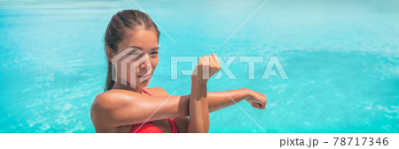 Fit woman stretching arm warm-up before running workout routine on blue background panoramic banner. 78717346