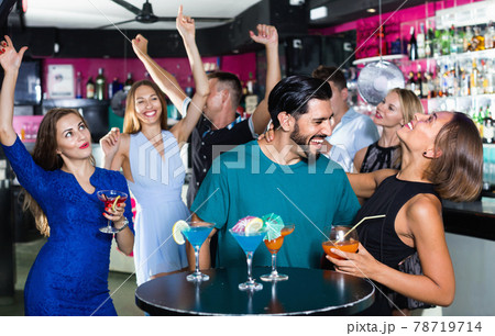 Man with young female are enjoying the party in bar. 78719714