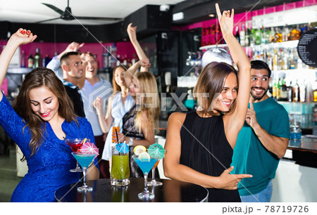 Women are drinking cocktails and having fun in nightclub. 78719726