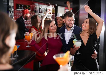 Guy with two girls partying in bar 78719845