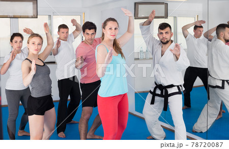 Young adult trainees practicing in karate class Young adult trainees practicing in karate class 78720087