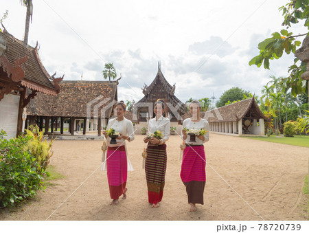 Portrait of group of Asian Shan women girls, Tai Yai, northern Thai people with traditional Lanna clothes holding flowers at Wat Ton Kwen temple, lanterns decoration. Culture lifestyle. Portrait of group of Asian Shan women girls, Tai Yai, northern Thai people with traditional Lanna clothes holding flowers at Wat Ton Kwen temple, lanterns decoration. Culture lifestyle. 78720739